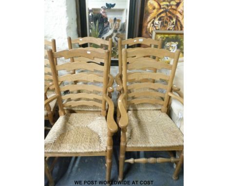A set of seven (5+2) Arts & Crafts oak ladder back rush seated chairs