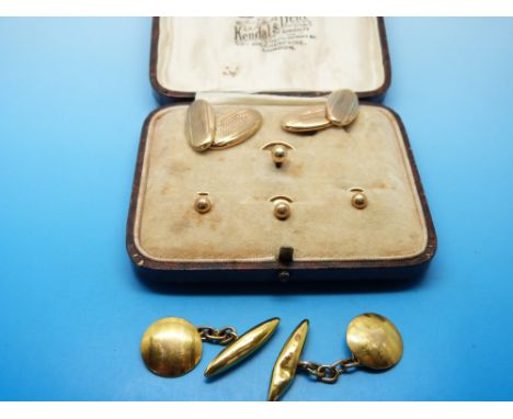 A pair of 9ct gold cufflinks with engine turned design and matching 9ct gold studs in original box and a further pair of 9ct 