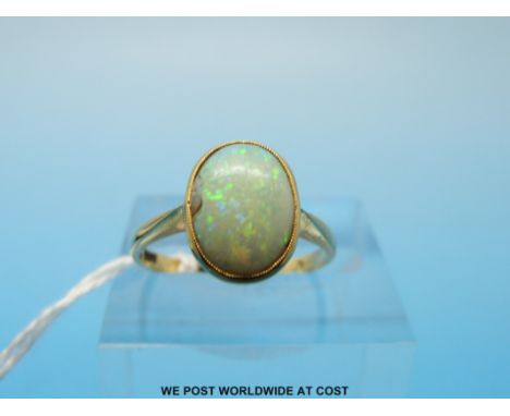 A gold ring set with an oval opal (size K) 