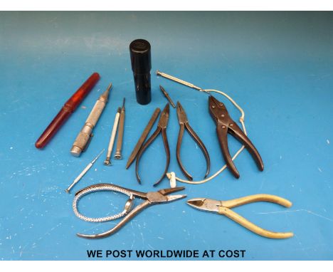 A quantity of watchmakers tools including Moore and Wright screwdriver set, pliers and a Cyma watch. 