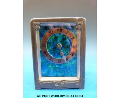 An Archibald Knox for Liberty and Co carriage clock with Arts and Crafts pewter case and copper and enamel dial. Stamped to u