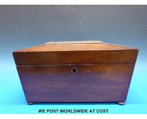A 19thc mahogany sarcophagus shaped tea caddy with bun feet