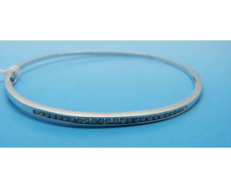 A 9ct white gold bangle set with diamonds 