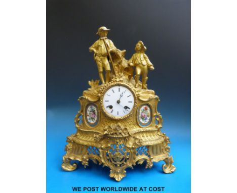 A two train brass mantel clock with Sevres style panels and two figures to the top.  
