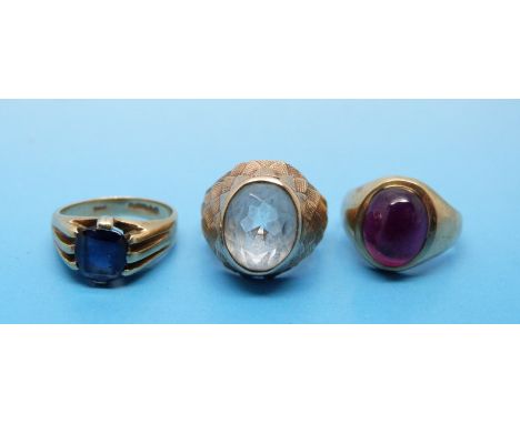 Three 9ct gold rings, one set with quartz, one with a sapphire and the other a ruby