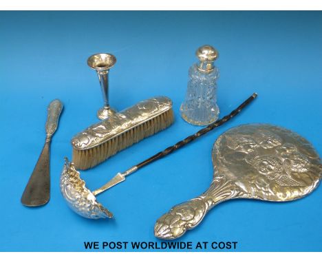 A hallmarked silver whale bone handled toddy ladle, hallmarked silver topped glass dressing table bottle, silver mounted mirr