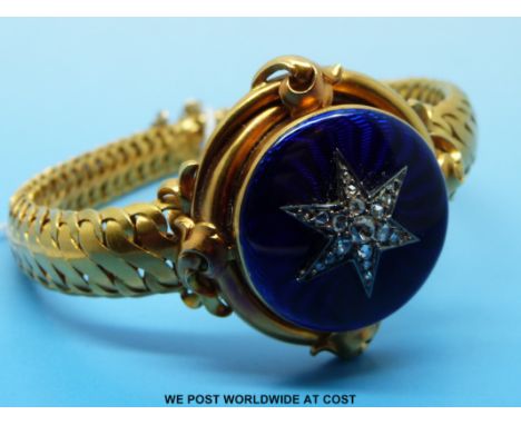 A Victorian bracelet with woven strap and a central blue guilloché enamel circular panel set with a star of old cut diamonds,