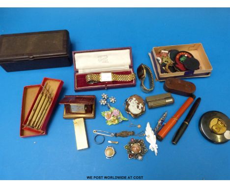 A collection  of brooches including a Victorian silver example, badges and jewellery-making tools, watches, pens, rabone tape