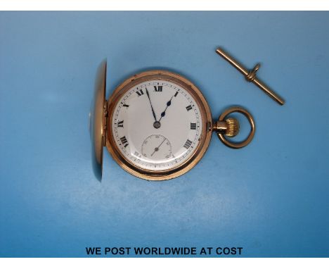 A Swiss made keyless 9ct gold half hunter pocket watch with an enamel face and Roman numerals together with a 9ct gold T bar