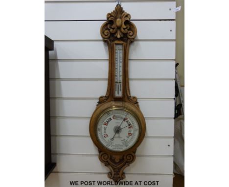 A mid 20thC aneroid barometer marked G Parkin, Newcastle upon Tyne, in carved case