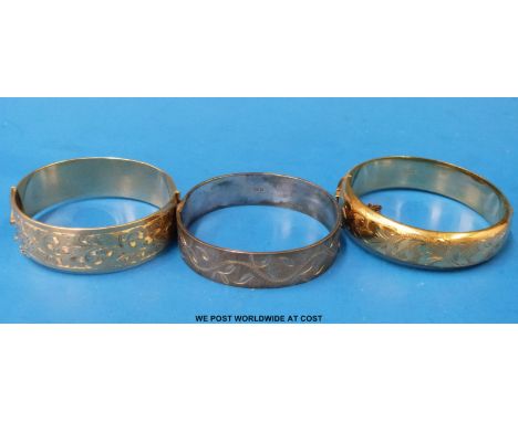 One silver bangle and two rolled gold bangles 