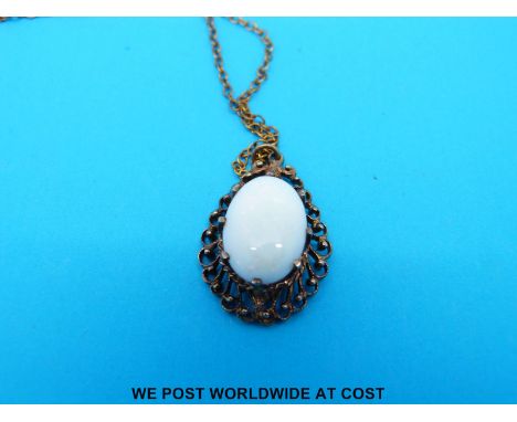 A 9ct gold pendant set with an oval opal