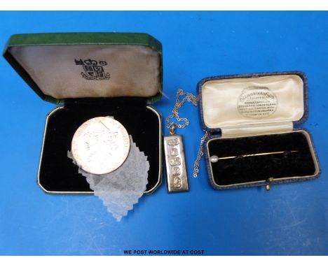 A feature hallmarked silver ingot, a National Trust cased coin and a yellow metal and pearl stick pin