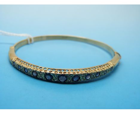 A 9ct gold bangle set with sapphires and diamonds 