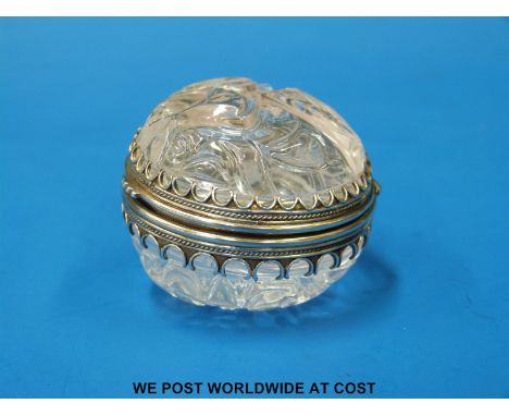 A possibly Russian carved rock crystal and white metal mounted trinket or dressing table box with hinged lid (5cm diameter)