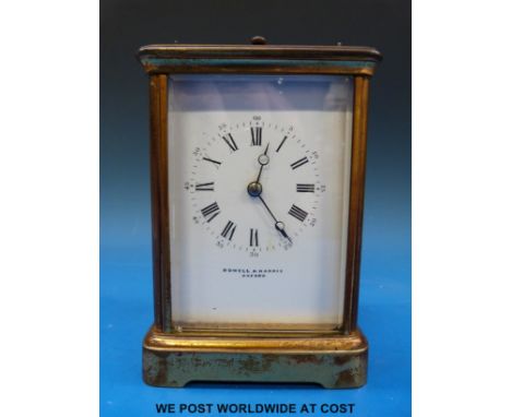 A brass carriage clock by Rowell and Harris Oxford, striking on a gong, in original case