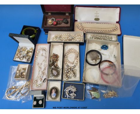 A large collection of costume jewellery to include faux pearls, a transfer printed brooch, earrings to include a silver and p