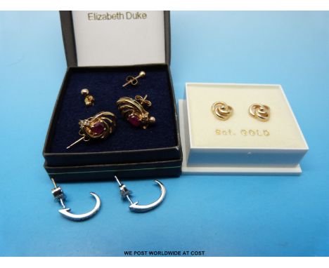 A pair of 9ct gold earrings each set with a ruby and a diamond, three yellow metal pairs of earrings marked 375 and a pair of