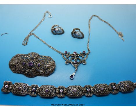 A silver suite of jewellery to include bracelet, necklace, earrings and brooch set with marcasite and amethyst