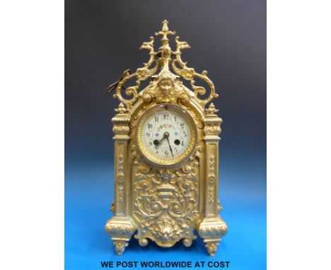 A gilt bronzed cased mantel clock with anonymous French movement striking on a bell, ivory coloured dial with floral and foli