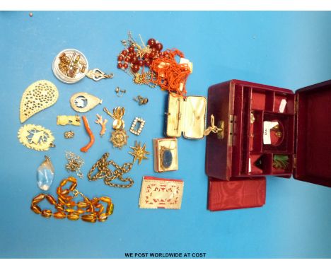A lapis lazuli and white metal necklace, a translucent amber necklace, coral piece, mother of pearl book cover, bone pendants