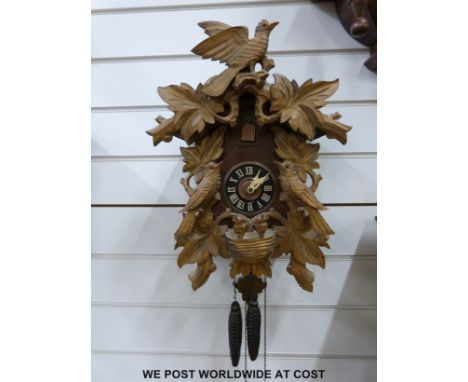 A c1945 wall cuckoo clock with finial, stamped "made in Western Germany" to the mechanism, with plastic bird, two bellows and