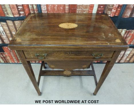 A late 19thC rosewood games table, the fold over top having chess, backgammon and cribbage boards with drawer and pull out tr