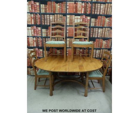 An Ercol light elm dining table with folding additional leaf and four ladder-backed chairs (Height of table 74, W165, D108cm)