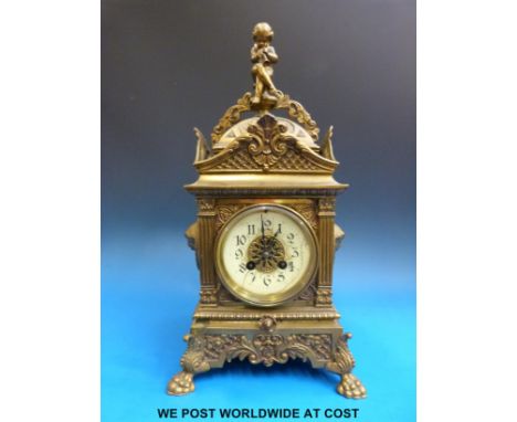 A late 19thC brass mantel clock with enamel dial and two-train movement. Stamped DC & Co to the movement and mounted on four 