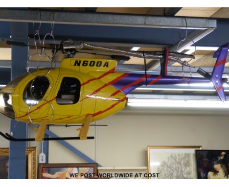 A remote control petrol helicopter with Hitec Aurora 9 2.4  Ghz transmitter, engine fitted is an O.S. 46