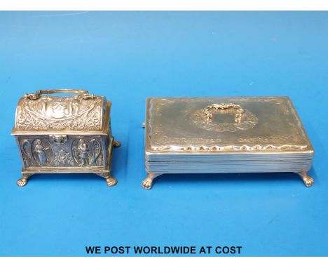 A continental white metal trinket box with swing handle raised on four paw feet (width 13cm) together with a Dutch white meta