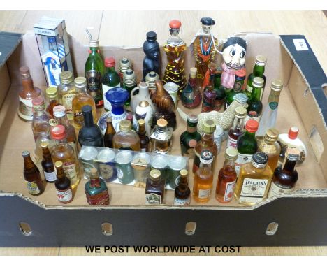 A collection of alcohol miniatures to include novelty china and glass bottles in the form of light bulbs, an eagle , Loch Nes