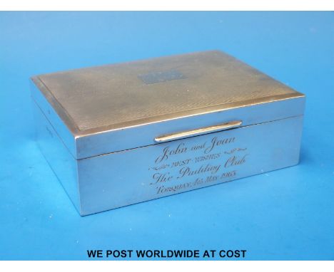 A hallmarked silver cigarette box with engine turned lid (width 11.5cm)