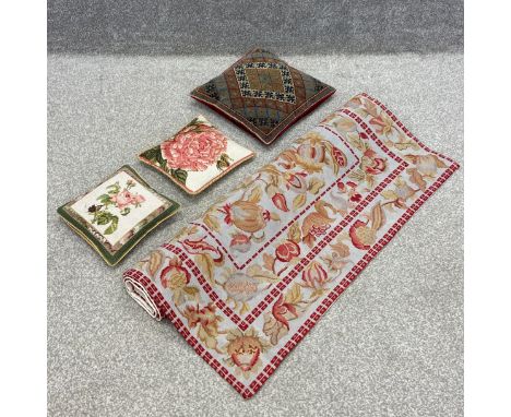 A wall hanging tapestry with all-over floral designs along with three needlework cushions. L.173 W.109cm
