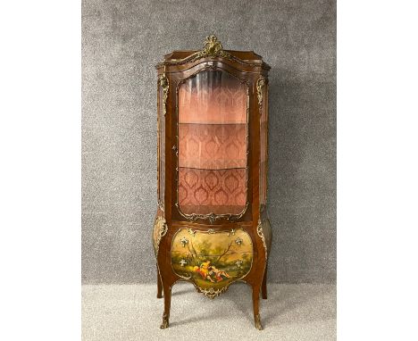 A Louis XV style vitrine or display cabinet having an arched caddy topped cornice mounted with an ormolu cresting above a gla