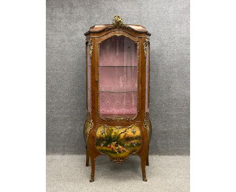 A Louis XV style vitrine or display cabinet having an arched caddy topped cornice mounted with an ormolu cresting above a gla