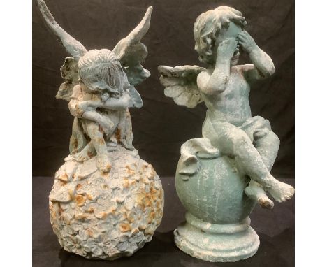 A cast iron garden model of a fairy seated on a ball of flowers, 31cm high; another similar, putto on sphere (2) 