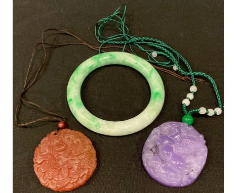 A Chinese jade bangle; a flying horse pendant; a dragon and phoenix pendant 