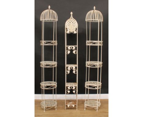A pair of architectural stamped metal four-tier plant display stands, 202cm high, each plateau 33.5cm diameter; another, 191c