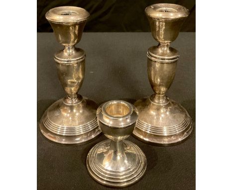 A pair of hallmarked silver candlesticks; a single hallmarked silver candlestick (3) 