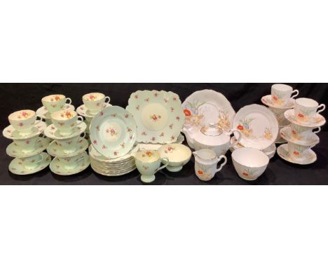 A Foley China tea service for twelve, flowers on a pale green ground, comprising cake plates, side plates, cream jug, sugar b