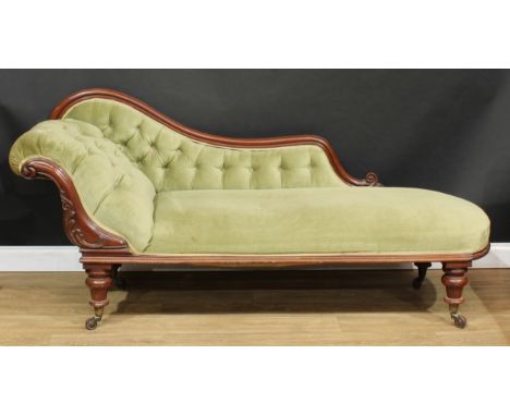 A Victorian mahogany scroll end chaise longue, carved with scrolling acanthus, turned legs, ceramic casters, 89cm high, 194cm