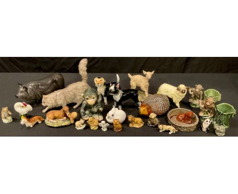 A Royal Doulton ceramic model of a Vietnamese Pot Bellied Pig; another, Cat; a Goebel model of an infant chimpanzee; other an