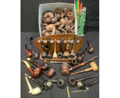 A large collection of briar pipe boxes/pipes and pipes in rack 