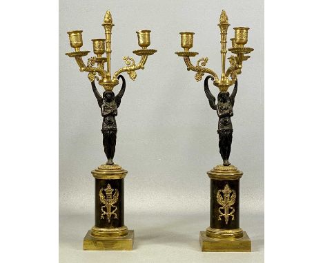 PAIR OF EMPIRE STYLE FIGURAL THREE-BRANCH CANDELABRA, ormolu and patinated bronze, with central flame finials, on pedestal st