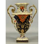 DERBY TWO-HANDLED OVOID PEDESTAL VASE, c. 1820, painted in Imari colours with gilded highlights,
