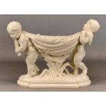 WILLIAM BROWNFIELD & SONS WHITE GLAZED FLOWER BOWL, formed as two cherubs carrying a fishing net, on