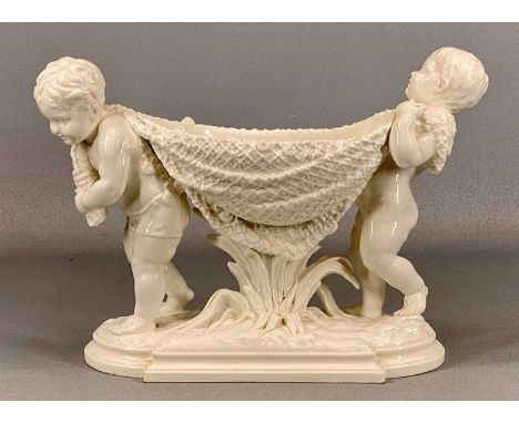 WILLIAM BROWNFIELD & SONS WHITE GLAZED FLOWER BOWL, formed as two cherubs carrying a fishing net, on naturalistic base, impre