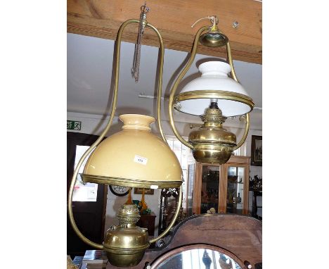 Large Victorian brass hanging oil lamp with yellow glass shade, together with a Victorian French brass hanging oil lamp with 