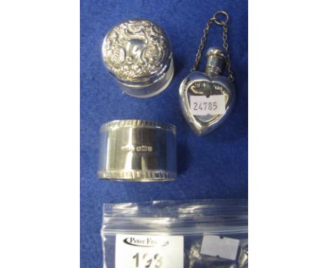 Glass silver topped dressing table jar, silver heart shaped scent bottle and silver napkin ring. (3)(B.P. 24% incl. VAT)